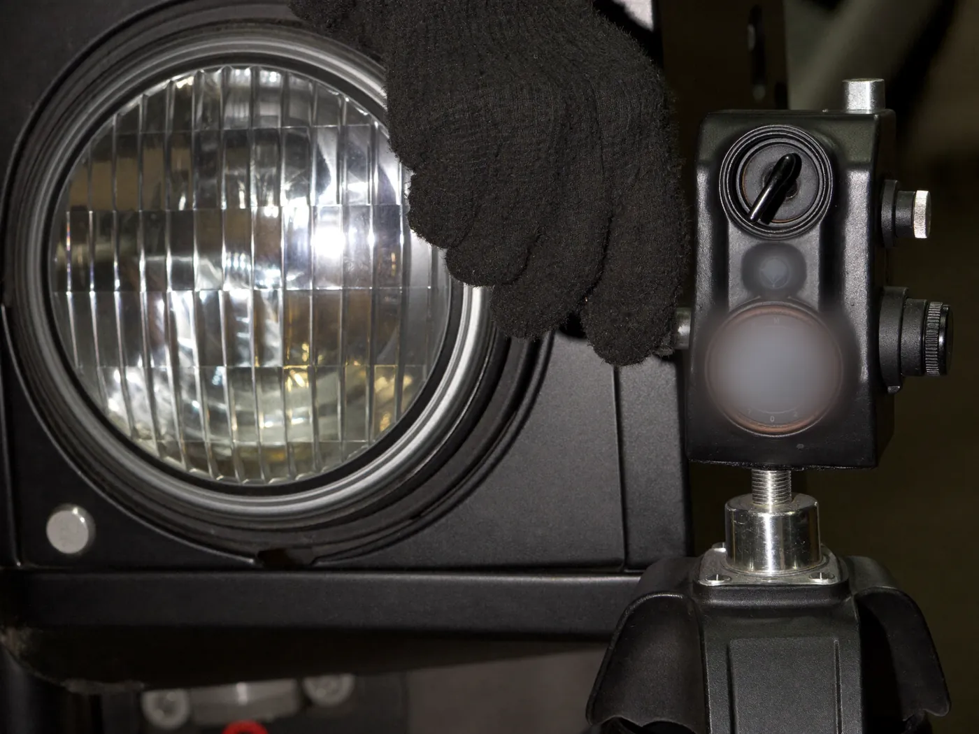 A headlamp being aligned with a beam setter in a workshop